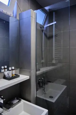a bathroom with a shower and a sink and a sink at Homz AH03 Penthouse Studio Hilton Area in Athens