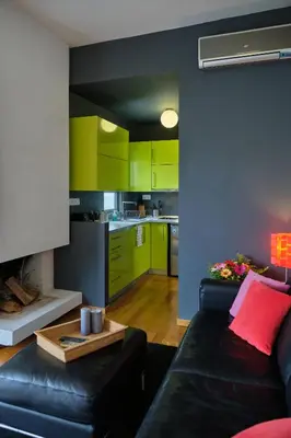 a living room with a black couch and green cabinets at Homz AH03 Penthouse Studio Hilton Area in Athens