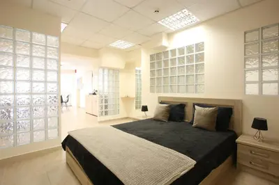 a bedroom with a large bed and some windows at GK Airport Suites - Free Shuttle by GK Properties in Markopoulo