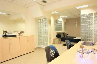 a living room with a table and chairs and a couch at GK Airport Suites - Free Shuttle by GK Properties in Markopoulo