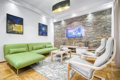 a living room with a green couch and chairs at Athens Alex Apartment in Athens