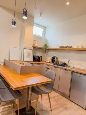 a kitchen with a wooden table and chairs in it at AS Monastiraki Apartment 1B in Athens