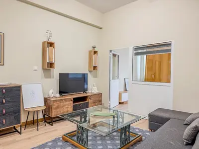 a living room with a couch and a tv at AS Monastiraki Apartment 1B in Athens