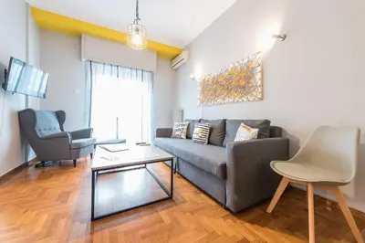 a living room with a couch and a chair at Athens Boutique Apartment by Cloudkeys in Athens