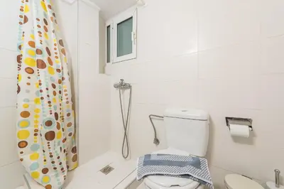 a bathroom with a toilet and a shower curtain at Athens Boutique Apartment by Cloudkeys in Athens
