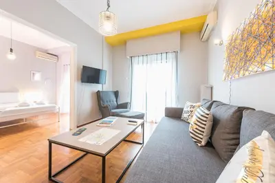 a living room with a couch and a table at Athens Boutique Apartment by Cloudkeys in Athens