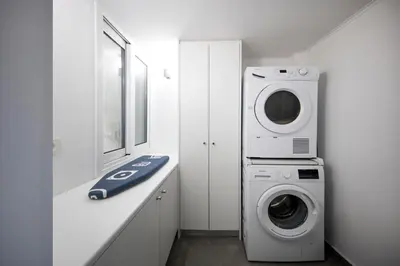 a laundry room with a washer and dryer in it at Kolonaki Square Executive Apartment in Athens