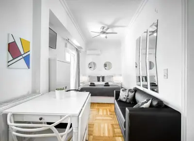 a living room with two beds and a couch at The Cactus Apartment with Large Sunny Balcony in Athens