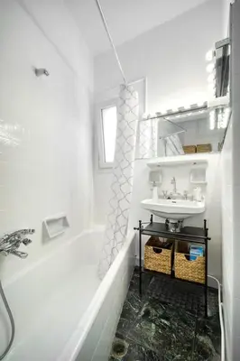 a white bathroom with a sink and a bath tub at The Cactus Apartment with Large Sunny Balcony in Athens