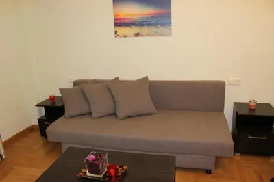 a living room with a couch and a table at Comfortable apartment in the center of Athens in Athens