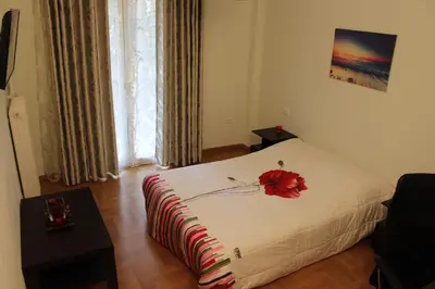 a bedroom with a bed with a red flower on it at Comfortable apartment in the center of Athens in Athens