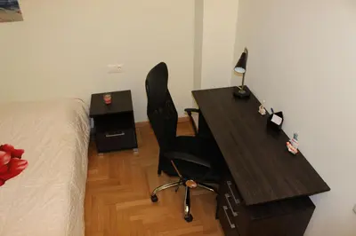 a bedroom with a desk with a chair next to a bed at Comfortable apartment in the center of Athens in Athens