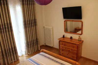 a room with a mirror and a dresser with a mirror at Comfortable apartment in the center of Athens in Athens