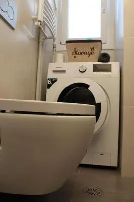 a washing machine with a toilet in a bathroom at Comfortable apartment in the center of Athens in Athens