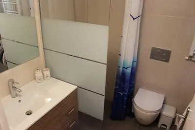 a bathroom with a sink and a toilet and a mirror at Comfortable apartment in the center of Athens in Athens