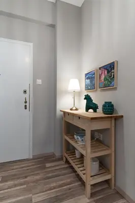 a room with a table with a lamp on it at Αbsolute Athens VIII in Athens