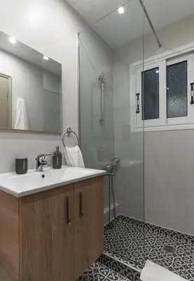 a bathroom with a sink and a shower at Αbsolute Athens VIII in Athens