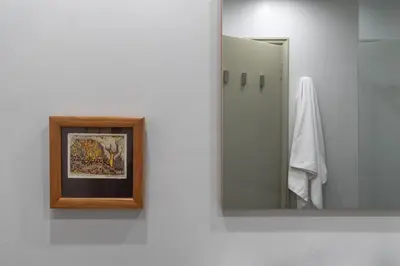 a bathroom with a mirror and a picture on a wall at Αbsolute Athens VIII in Athens