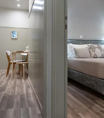 a bedroom with a bed and a table with a chair at Αbsolute Athens VIII in Athens