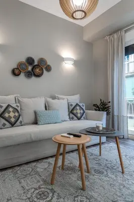 a living room with a couch and a table at Αbsolute Athens VIII in Athens