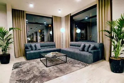 a living room with two couches and a coffee table at Athens Iris Hotel in Athens