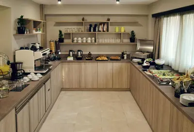 a kitchen with a counter with food on it at Athens Iris Hotel in Athens