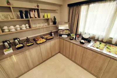 a buffet in a restaurant with food on display at Athens Iris Hotel in Athens