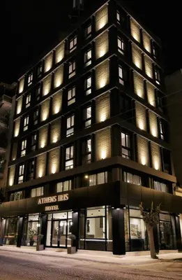 an office building with lights on at night at Athens Iris Hotel in Athens
