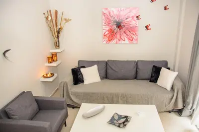 a living room with a couch and a table at Neighborly Nest - Apartment in the heart of Athens in Athens
