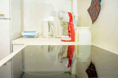a kitchen counter with a red appliance on a shelf at Neighborly Nest - Apartment in the heart of Athens in Athens