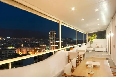 a balcony with a view of the city at night at Athens 360 penthouse, panoramic City view in Athens