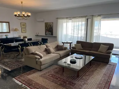 a living room with a couch and a table at Athens 360 penthouse, panoramic City view in Athens