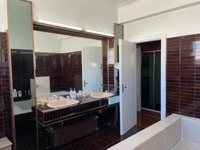 a bathroom with two sinks and a large mirror at Athens 360 penthouse, panoramic City view in Athens