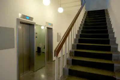 a staircase in a building with a glass door at Athens 360 penthouse, panoramic City view in Athens
