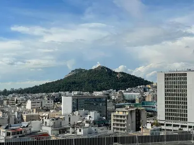 a view of a city with a mountain in the background at Athens 360 penthouse, panoramic City view in Athens