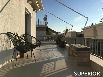 a patio with two benches and a balcony at Sunkissed Rooftop Apartments in Athens