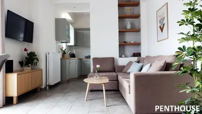 a living room with a couch and a table at Sunkissed Rooftop Apartments in Athens