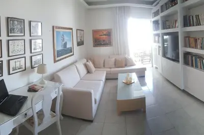 a living room with a white couch and a table at Elegant Athenian Apartment in Athens