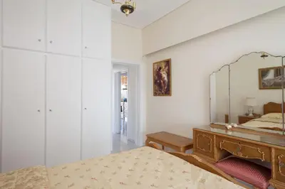 a bedroom with a large mirror and a bed at Elegant Athenian Apartment in Athens