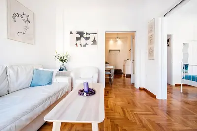 a living room with a white couch and a table at Acropolis Exceptional View in Athens