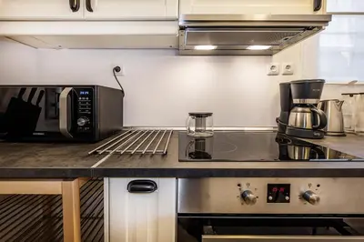 a kitchen with a microwave and a coffee maker on a counter at Acropolis Exceptional View in Athens