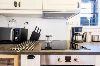 a kitchen counter with a microwave and a coffee maker at Acropolis Exceptional View in Athens