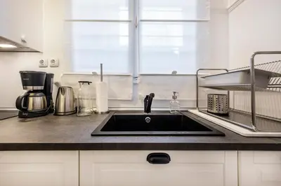 a kitchen counter with a sink and a window at Acropolis Exceptional View in Athens