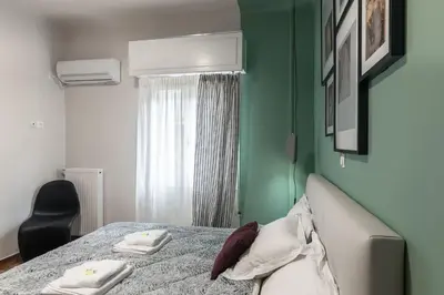 a bedroom with a bed and a green wall at Athenian LInes, 50 meters from Acropolis Museum in Athens