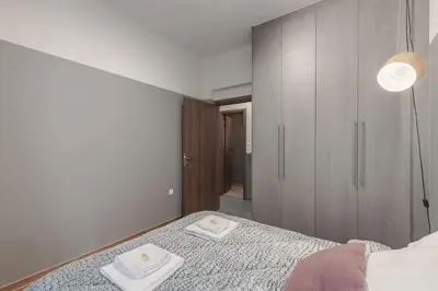 a bedroom with a bed with two towels on it at Athenian LInes, 50 meters from Acropolis Museum in Athens
