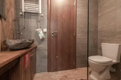 a bathroom with a toilet and a glass shower at Athenian LInes, 50 meters from Acropolis Museum in Athens