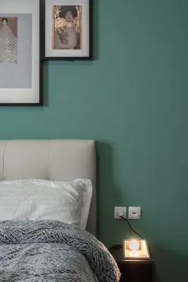 a bedroom with a bed and two pictures on the wall at Athenian LInes, 50 meters from Acropolis Museum in Athens