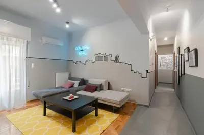 a living room with a couch and a table at Athenian LInes, 50 meters from Acropolis Museum in Athens