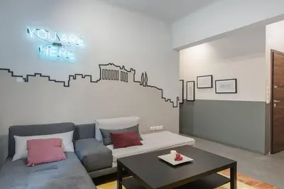 a living room with a couch and a table at Athenian LInes, 50 meters from Acropolis Museum in Athens