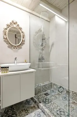 a white bathroom with a sink and a mirror at Acropolis Memories in Athens